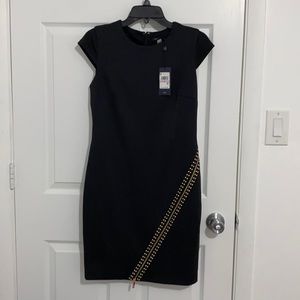 Black dress with an asymmetrical zip.